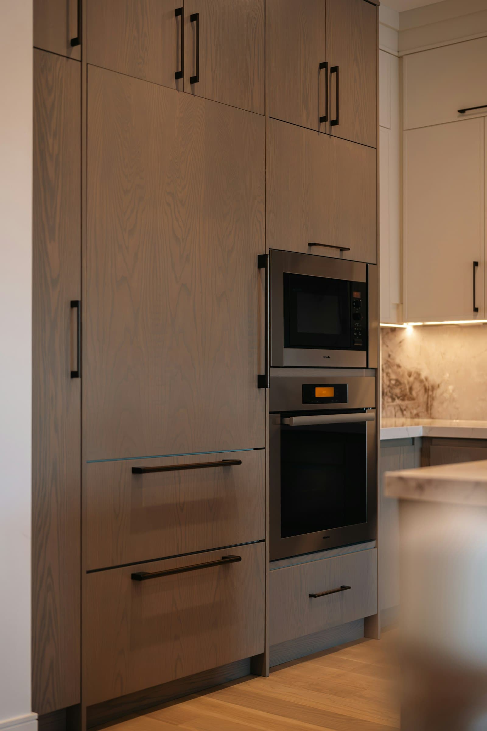 Built-in wall oven and microwave in custom wood cabinetry