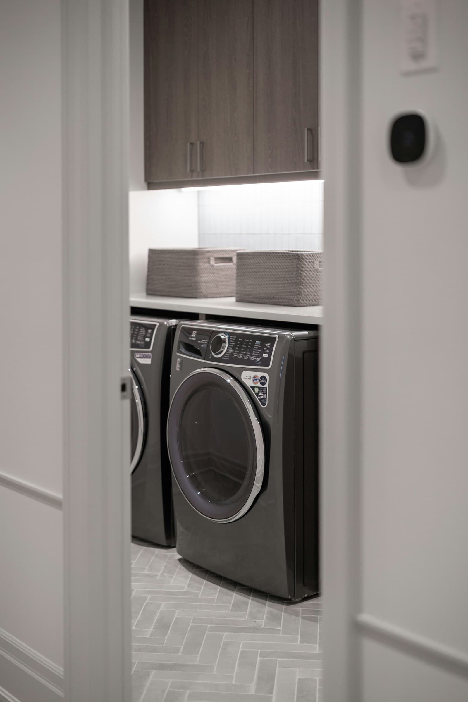 Modern laundry room with a front-load dryer built into cabinetry