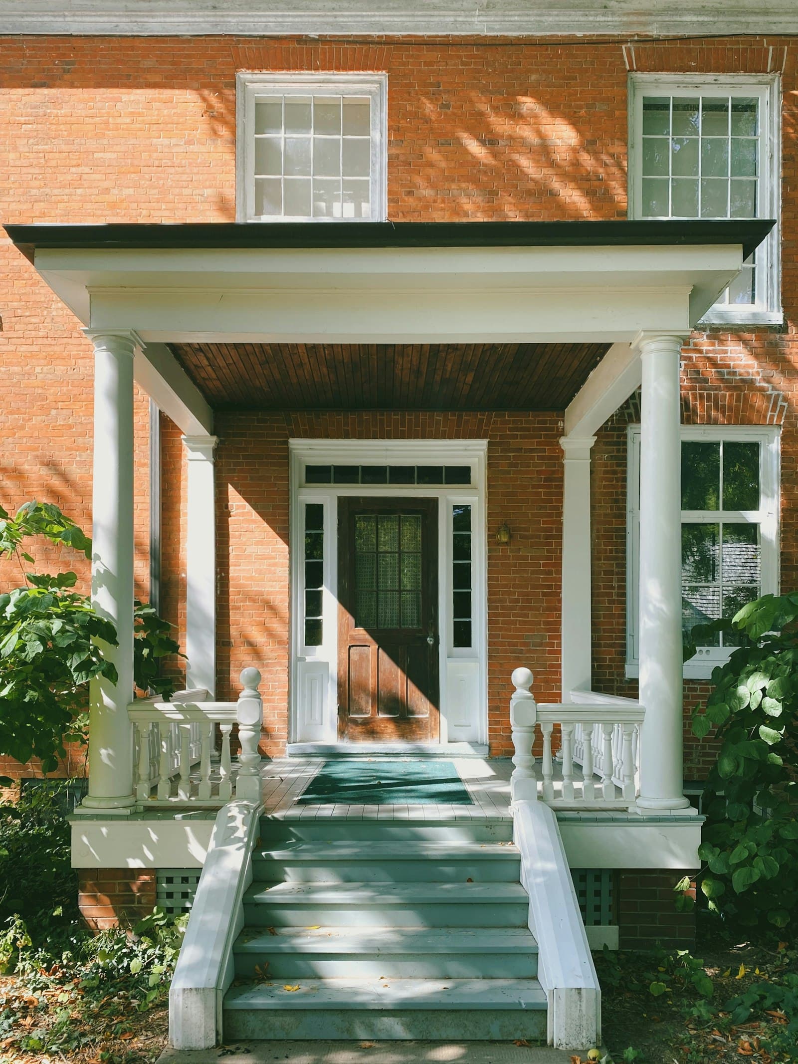 Brick residential home exterior with a covered front porch